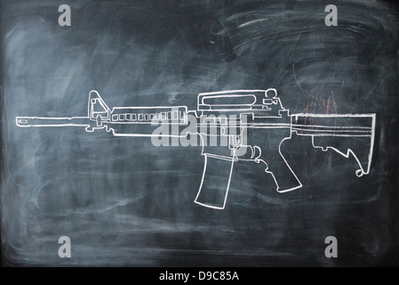 Chalk disegno della pistola sulla lavagna Foto Stock