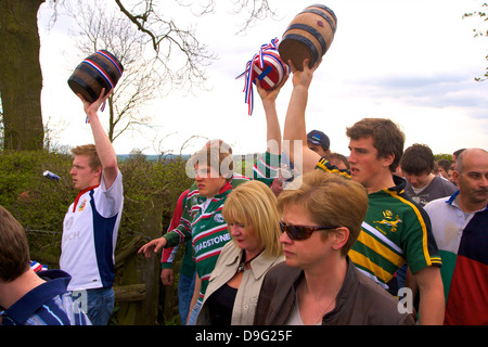 I partecipanti del corteo per il vecchio personalizzato annuale della bottiglia a calci, Hallaton, Leicestershire, England, Regno Unito Foto Stock