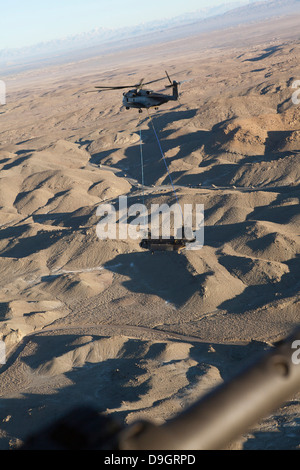 Un CH-53E Super Stallion trasporta un CH-47 Chinook oltre l'Afghanistan. Foto Stock