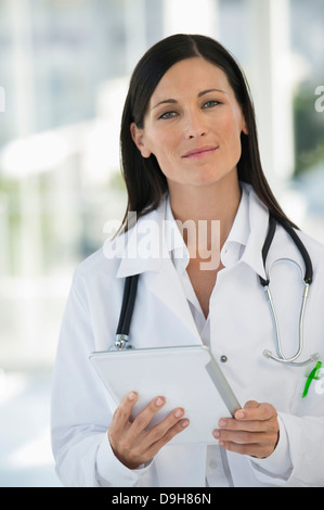 Ritratto di un medico di sesso femminile in possesso di una tavoletta digitale Foto Stock
