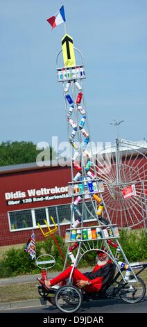 Storkow, Germania, 20 giugno 2013. Noleggio designer Dieter (Didi) Senft presenta la sua nuova bicicletta unico con una torre Eiffel in cima a Storkow, Germania, 20 giugno 2013. Il 'Tour Teufel' (lit: tour del diavolo) da Senft consiste di un triciclo coricata con un 5.9 m alto Tour de France che è decorato con 55 bottiglie di bevande. Essa è stata realizzata per il centenario del Tour de France di quest'anno. Senft è noto per la sua unica e biciclette e ha 17 voci nel Guinness dei record. Foto: PATRICK PLEUL Credito: dpa picture alliance/Alamy Live News Foto Stock