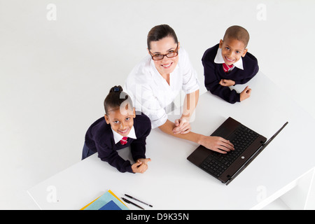 Vista aerea del maestro elementare e studente di fronte a un computer portatile Foto Stock