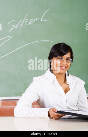 Giovane insegnante della scuola seduti in classe Foto Stock