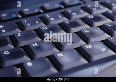 Una tastiera nero illuminato da schermo del computer. Messa a fuoco selettiva. Foto Stock