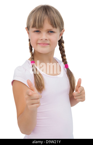 Graziosa bambina dando pollice in alto Foto Stock