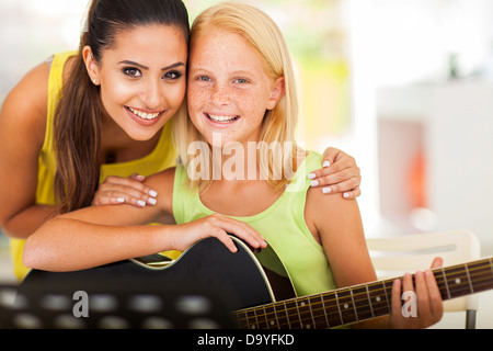 Attraente insegnante di musica e preteen ragazza con una chitarra Foto Stock