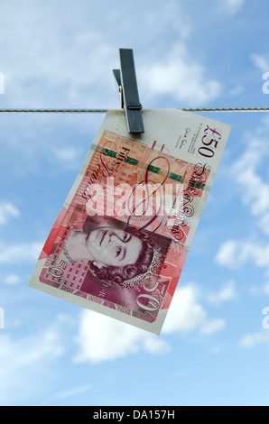 Cinquanta Pound Notes appeso su una linea di lavaggio Foto Stock