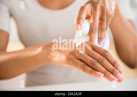 Close up di donna con le mani in mano l'applicazione di crema idratante Foto Stock