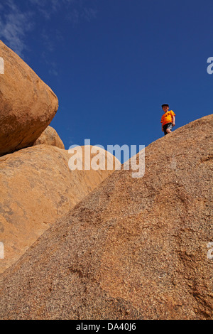 Ragazzo su giganteschi massi a Spitzkoppe, Namibia, Africa Foto Stock