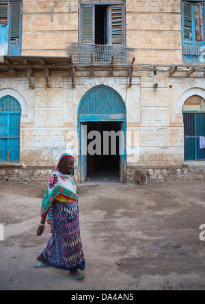 Donna passando davanti ad una architettura ottomana edificio, Massaua, in Eritrea Foto Stock