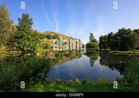 Kilnsey Crag e Parco Kilnsey Trota Lago, Kilnsey, Wharfedale, North Yorkshire, Yorkshire Dales National Park, Inghilterra, Regno Unito. Foto Stock