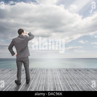 Ben vestito uomo d affari in piedi su tavole di legno Foto Stock