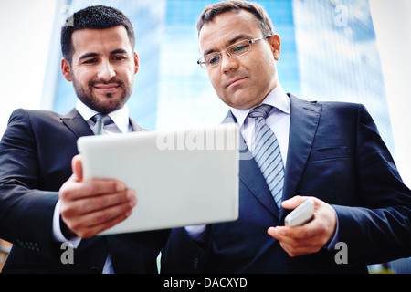 I colleghi per discutere soluzioni business mentre la riunione in ambienti urbani Foto Stock