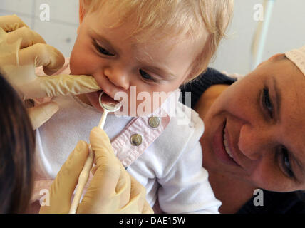 Un dentista esamina i denti di un uno-anno-vecchio all'ambulatorio unità di ricerca progetto LIFE-bambino, un progetto del centro di ricerca per le malattie civilisational dell'Università di Leipzig in Lipsia, Germania, 15 settembre 2011. In Germania il più grande progetto di ricerca per le malattie civilisational mira a esaminare più di 5 mila bambini all'età di 0-18 anni e circa 10 Foto Stock