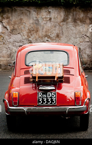 Vintage orange Fiat Bambino 500 parcheggiato per le strade di Roma, Italia Foto Stock