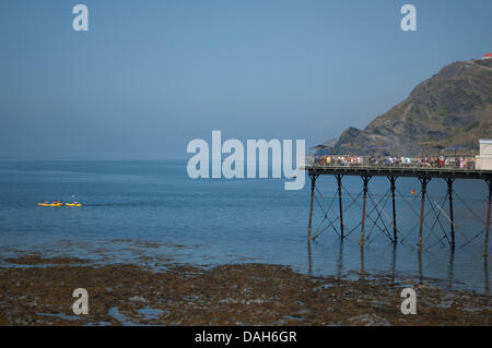 Aberystwyth, Wales, Regno Unito. 13 luglio 2013. Le persone che si godono le estati calde giorno in Aberystwyth, sia esso avente una bevanda fredda sul molo, o kayak sul piatto e limpido mare di Cardigan Bay. Credito: Barry Watkins/Alamy Live News Foto Stock