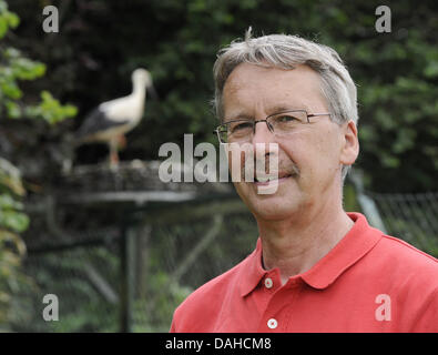 Berna, Germania. 04 Luglio, 2013. Udo Hilfers, manager della cicogna struttura di cura Wesermarsch fornisce una introduzione sulla vita delle cicogne e protezione della natura per i visitatori della struttura nei pressi di Berna, Germania, 04 luglio 2013. La maggior parte delle cicogne presso la struttura che è stata fondata nel 1992 restare temporaneamente; solo alcuni di loro hanno bisogno di essere prese in considerazione per un periodo di tempo più lungo. Foto: INGO WAGNER/dpa/Alamy Live News Foto Stock