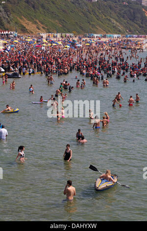 Bournemouth, Regno Unito 14 luglio 2013. British Heart Foundation molo di Bournemouth Pier nuotare, il più grande carità nuotare in Europa come sostenitori coraggiosi il canale in inglese in questo 1.4 miglio open water swim, partendo dal molo di Bournemouth nuotatori sono messi alla prova in questa impegnativa mare che nuotano lungo il litorale di Boscombe Pier. Nuotatori prendere al mare nella soffocante temperature, nonché evitando di masse di visitatori in mare, sperando di sollevare £180.000 per la carità. Ci si aspetta che siano circa 1.200 al mezzogiorno di partenza, la seconda delle nuotate. Credito: Carolyn Jenkins/Alamy Live News Foto Stock