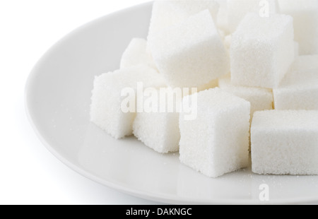 Zollette di zucchero nel piattino su sfondo bianco Foto Stock