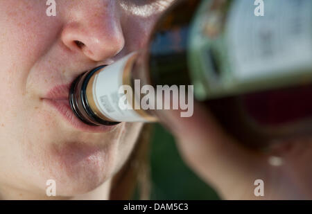 (FILE) un archivio foto datata 26 aprile 2011 mostra una giovane donna di bere una bottiglia di birra a Stuttgart, Germania. Federale in materia di droga il Commissario Dyckmans presenta la droga e le dipendenze relazione per il 2011 a Berlino. Foto: Uwe Anspach Foto Stock