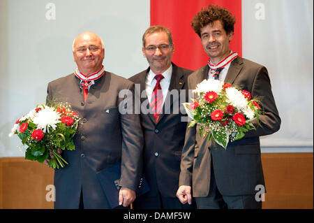 Brandeburgo Premier Matthias Platzeck (C) conferisce l'ordine di merito da parte dello stato di Brandeburgo al direttore del Uckermaerkischen Buehnen Schwedt (Uckermark Theatre Schwedt), Reinhard Simon (L), e l'ex direttore dell'Oper im Schloss Stettino (Opera in castello di Stettino in Szczecin, Polonia), Warcislaw Kunc a Potsdam, Germania, 10 giugno 2011. Il premier ha assegnato il o il Foto Stock