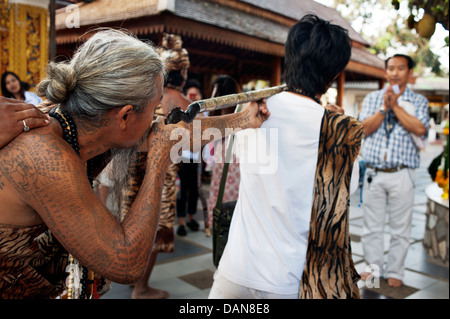 Pesantemente tatuato eremiti animista dire delle preghiere di guarigione e raccontare vicende a Doi Suthp tempio buddista in Chiang Mai, Thailandia. Foto Stock