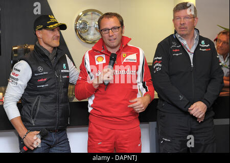 Italiano Stefano Domenicali (M), il team manager della Ferrari, e l'inglese Ross Brawn, team manager della Mercedes GP avente un discorso di ringraziamento per il tedesco pilota di Formula Uno Michael Schumacher della Mercedes GP a sua festa anniversario con la Mercedes GP motorhome sul circuito di Spa-Francorchamps vicino a Spa, Belgio, 27 agosto 2011. Al GP del Belgio 1991 Michael Schumacher ha guidato il suo primo per Foto Stock