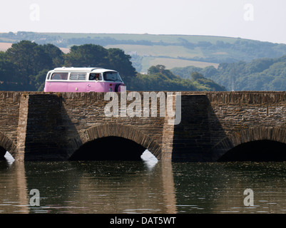 Rosa VW andando oltre il ponte sulla A379 oltre il Bowcombe Creek, vicino a Kingsbridge, Devon, Regno Unito 2013 Foto Stock