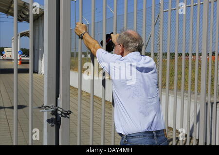 Griesheim, Germania. Il 20 luglio 2013. Un attivisti risuona a le porte esterne del complesso di pugnale. Membri della NSA Spy Tutela della società organizzata il 2° Spy Guarda la passeggiata e un picnic al di fuori del complesso di pugnale, un presunto centro di sorveglianza della NSA in Germania, per protestare contro la NSA in tutto il mondo della comunicazione del programma di sorveglianza PRISMA. Credito: Michael Debets/Alamy Live News Foto Stock