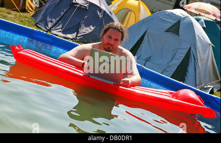 Joerg da Vienna ha posto il suo computer portatile su un materasso gonfiabile in una piscina durante durante il "Chaos Communication Camp 2007" sui composti del Museo dell'aviazione ("Luftfahrtmuseum') Finowfurt, Germania, 9 agosto 2007. Circa 1.200 appassionati di computer da Germania e altrove si sono riuniti per cinque giorni i Summer Camp, che vede se stesso come 'open air festival per hacker e si Foto Stock