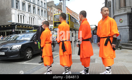 Shaolin Warriors attendere al semaforo su Dame Street dopo una chiamata premere durante l'accumulo di spettacoli presso il teatro Olimpia. Foto Stock