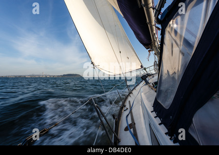 Vista ravvicinata della barca a vela da corsa, mentre si dirige verso il Bay Bridge nella baia di San Francisco in una giornata di sole Foto Stock