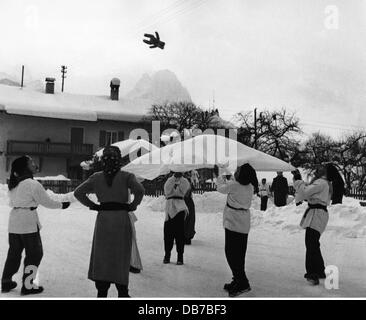 Feste, carnevale a Partenkirchen, bambini con maschere di legno che gettano orsacchiotto con coperta in aria, Garmisch - Partenkirchen, 1956, Additional-Rights-Clearences-Not Available Foto Stock