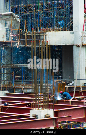 Un uomo di saldatura su di un sito in costruzione Foto Stock