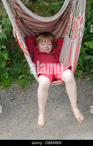 Giovane ragazzo in un'amaca Foto Stock