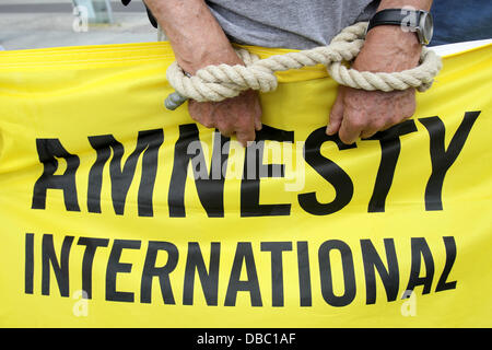 Gli attivisti di Amnesty International protesta per sollevare la consapevolezza per la situazione nel Mali e l'elezione federale entro il paese a Potsdamer Platz a Berlino, Germania, 28 luglio 2013. Amnesty International intende aumentare la consapevolezza per la preoccupante situazione del paese in materia di diritti umani, in particolare la crescente quantità di esecuzioni capitali nel paese africano e Dell'ovest. Foto: WOLFGANG KUMM Foto Stock