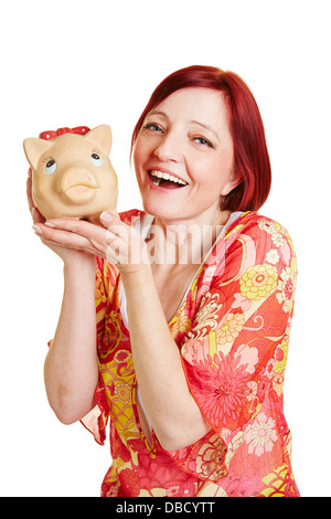 Sorridenti donna tenendo un grande salvadanaio Foto Stock
