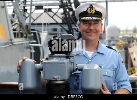 Bremen, Germania. 29 Luglio, 2013. Il comandante della fregata "Bremen", capitano di fregata Ingolf Schlobinsky, è raffigurato sulla sua nave nel porto di grano in Bremen, Germania, 29 luglio 2013. La nave della marina militare tedesca ha visitato la sua città partner per l'ultima volta. La nave sarà de-commissionato dopo la visita dopo 31 anni di servizio. Foto: INGO WAGNER/dpa/Alamy Live News Foto Stock