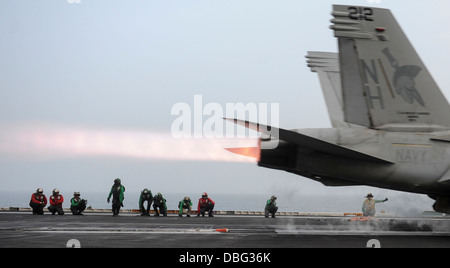 Stati Uniti I marinai in stand by come un F/A-18F Super Hornet aeromobile assegnati a Strike Fighter Squadron (VFA) 147 lancia dalla portaerei USS Nimitz CVN (68) Luglio 23, 2013, nel Mare Arabico. La Nimitz Carrier Strike gruppo è stato distribuito negli Stati Uniti 5. Foto Stock