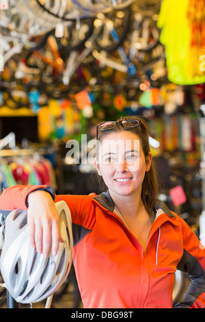 Caucasian woman standing in negozio di biciclette Foto Stock