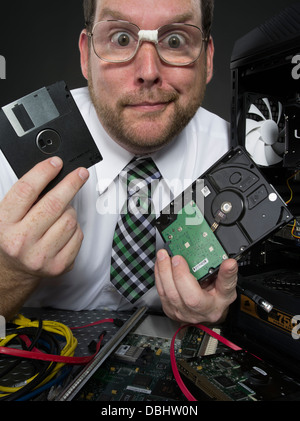 L'uomo con il computer e con vari componenti hardware Foto Stock