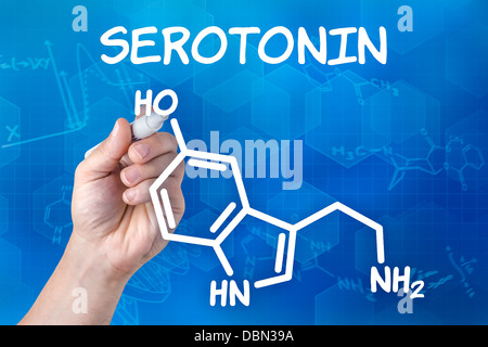 Mano con disegno a penna la formula chimica della serotonina Foto Stock