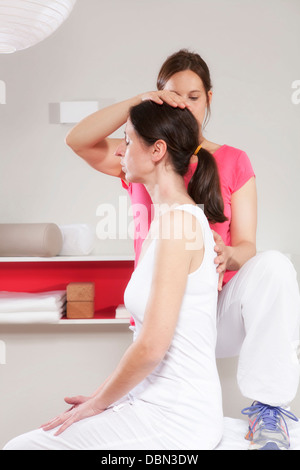 Paziente femmina di ricevere il trattamento da osteopata, Monaco di Baviera, Germania Foto Stock