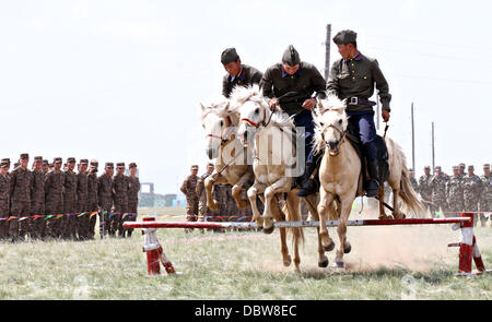 Membri della Mongolia le forze armate 234 unità di cavalleria dare una dimostrazione della loro abilità a cavallo durante la cerimonia di apertura dell'esercizio Khaan Ricerca Agosto 3, 2013 in cinque colline Area Formazione e Mongolia. Foto Stock