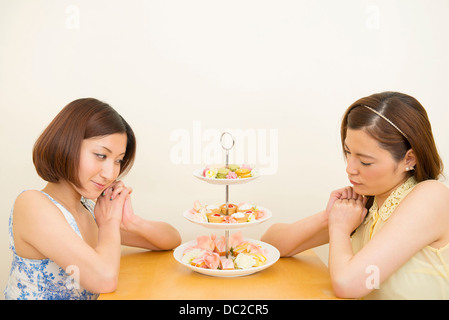 Due donne guardando assortimento di pasticceria Foto Stock