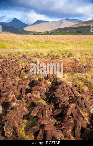 Torbiera in West Ireland, turf tagliare e giacente nel sole per asciugare. Foto Stock