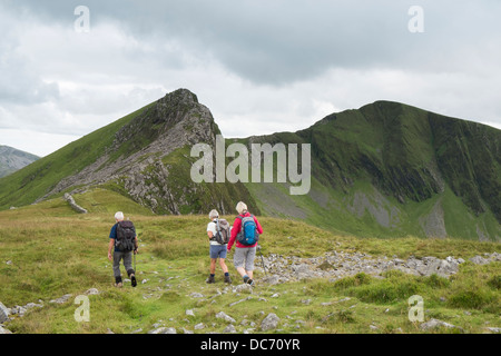 Walkers su Y Garn camminando verso Mynydd Drws-y-coed sulla cresta Nantlle camminare nelle montagne di Snowdonia Gwynedd North Wales UK Foto Stock