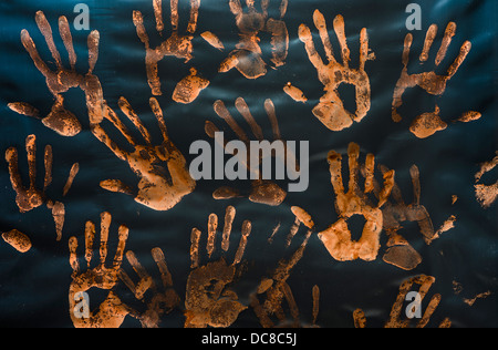 Handprints realizzata con vernice rossa sulla plastica Foto Stock