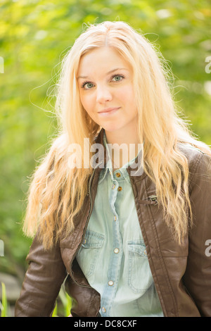 La natura in scena con un giovane attraente donna bionda in un parco Foto Stock