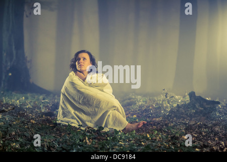 La donna nel buio e nebbioso vecchia foresta Foto Stock